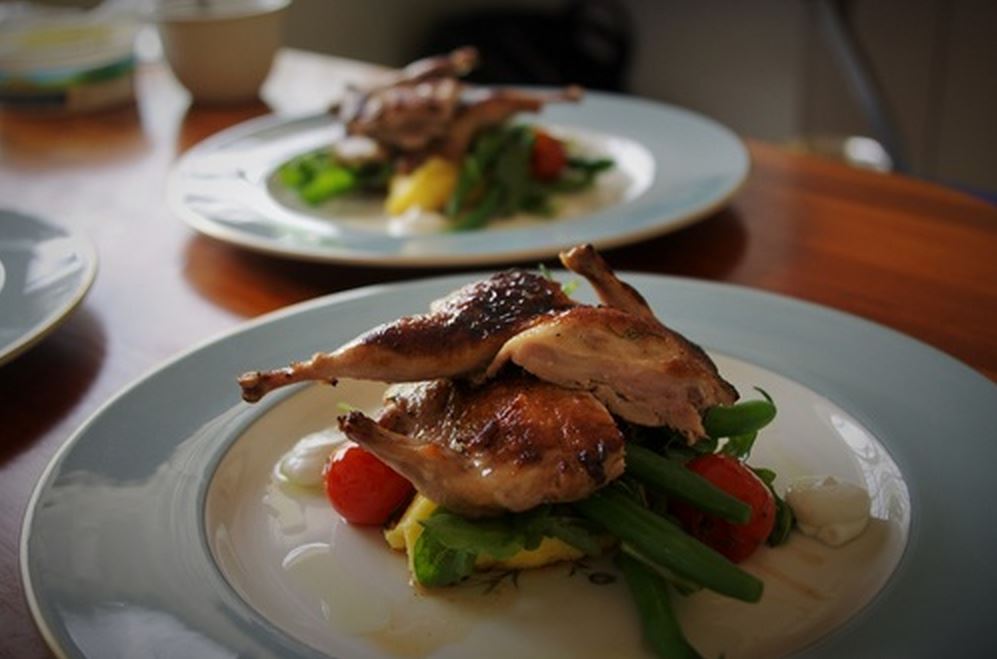 Grilled quail plated for dinner party
